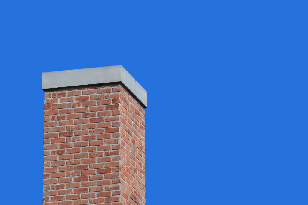 modern retro brick chimney design with blue sky background scaled